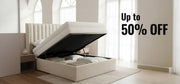 Beige upholstered bed with open storage compartment in a bright room, promotional text 'Up to 50% OFF' displayed.