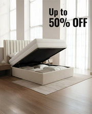 White bed with storage compartment in a room with large windows, promotional text 'Up to 50% OFF' displayed.