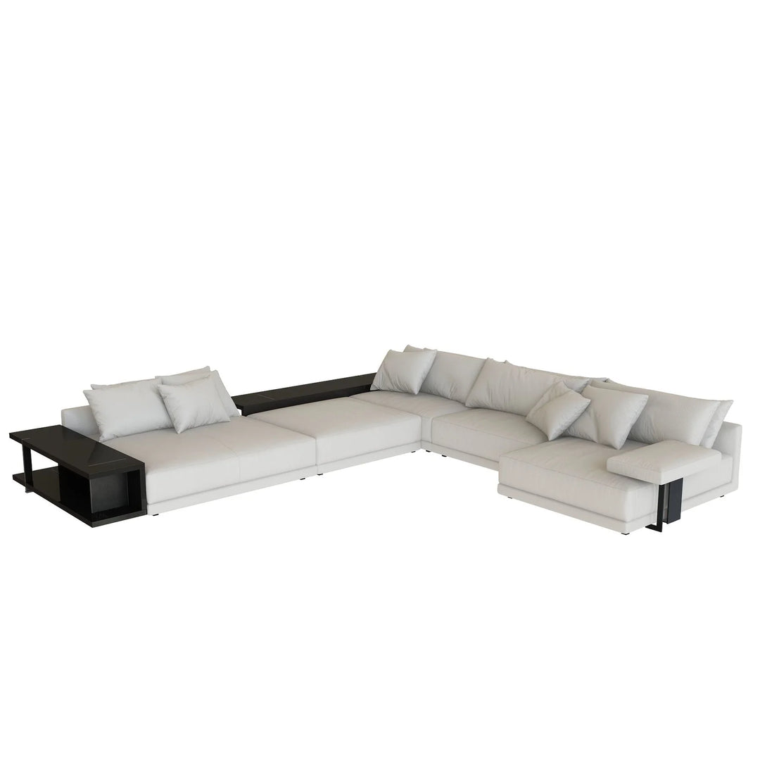 White sectional sofa with a small table on a white background