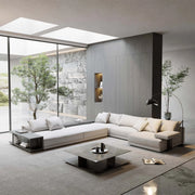 Modern living room with a large sectional sofa, coffee table, and decorative elements.