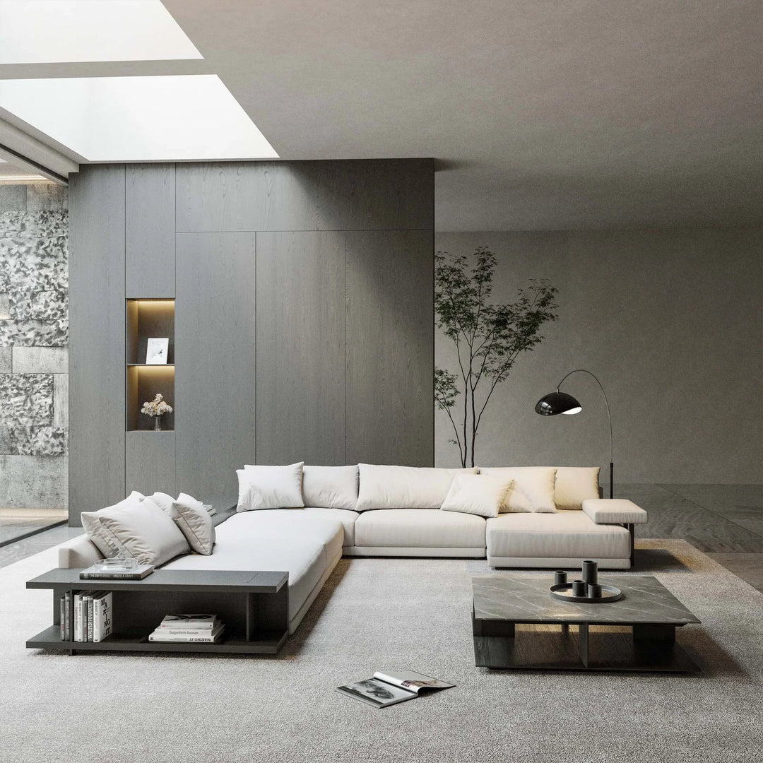 Modern living room with a white sectional sofa, coffee table, and decorative elements.