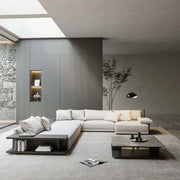 Modern living room with a white sectional sofa, coffee table, and decorative elements.