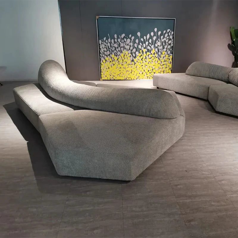 Modern living room with a gray sofa and abstract painting on the wall.