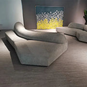 Modern living room with a gray sofa and abstract painting on the wall.