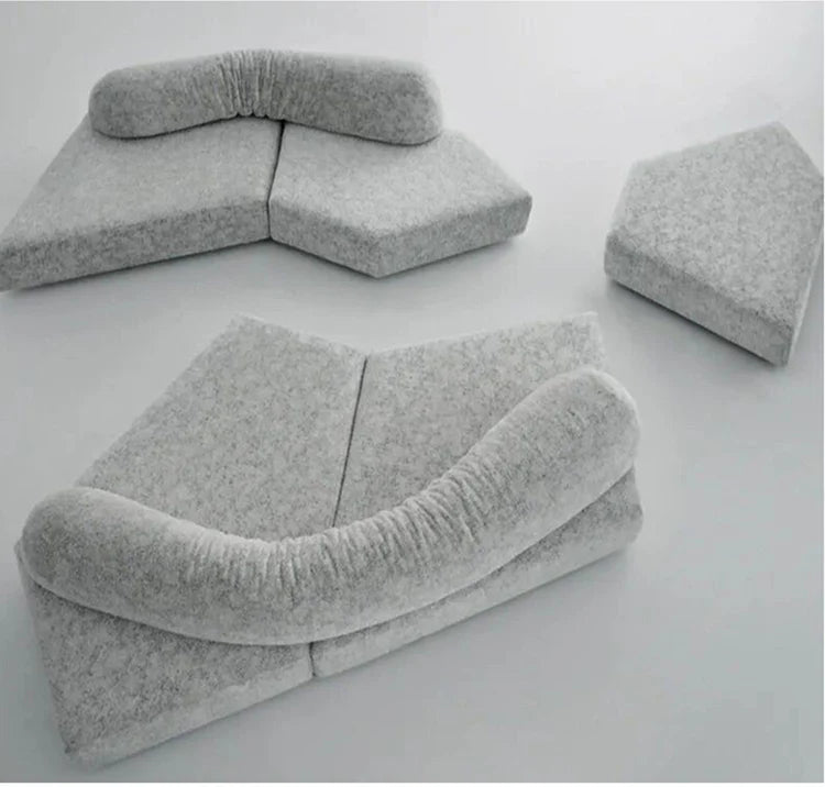 Gray cushioned sofa sectional on a white background