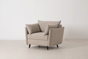 Beige armchair with cushions on a white background