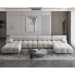 Load image into Gallery viewer, Modern living room with a large white sectional sofa, coffee table, and decorative elements.
