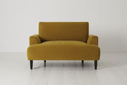 Mustard yellow armchair on a white floor and background