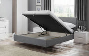Gray upholstered bed with storage compartment in a modern bedroom setting.