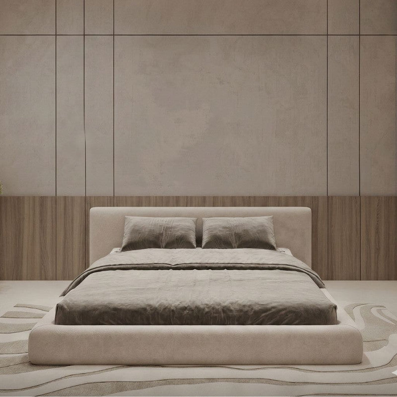 Beige bed in a room with wooden paneling