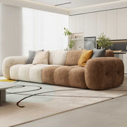 Modern living room with a multi-colored sofa and decorative pillows.