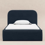 Load image into Gallery viewer, Navy bed frame with white mattress and pillow on a beige background