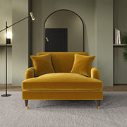 Mustard yellow sofa in a modern living room with a mirror and floor lamp.