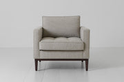 Gray armchair on a white floor with a white background