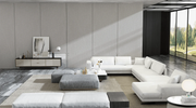 Modern living room with a white sectional sofa, gray ottomans, and a coffee table.