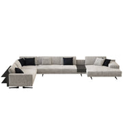Gray sectional sofa with black cushions on a white background