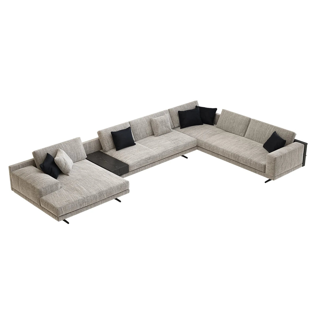 Gray sectional sofa with black and white pillows on a white background