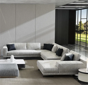 Modern living room with a gray sectional sofa and decorative pillows.