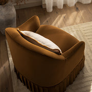 Brown cushioned ottoman with a pillow on a wooden floor.