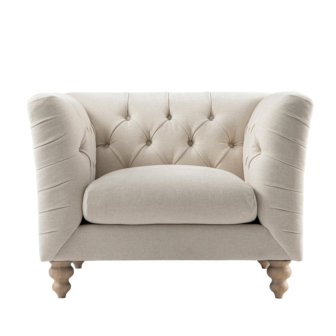 Beige armchair with tufted backrest on a white background