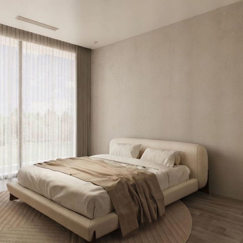 Modern bedroom with a beige bed and neutral decor
