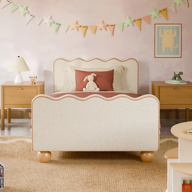 Children's bedroom with a decorative bed, nightstands, and wall art.