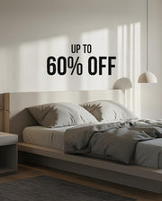 bed room with a cozy bed. written 60% off