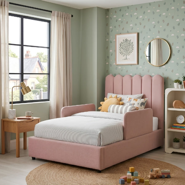 Children's bedroom with a pink bed, toys, and decorative elements.