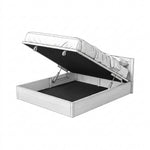 Load image into Gallery viewer, A white wooden storage bed frame with its mattress lifted open by gas springs, showing the dark interior storage compartment against a plain white background.