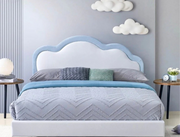 Bedroom with a bed featuring a blue and white headboard, gray bedding, and decorative pillows.