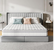 Gray upholstered bed with white mattress in a bedroom setting