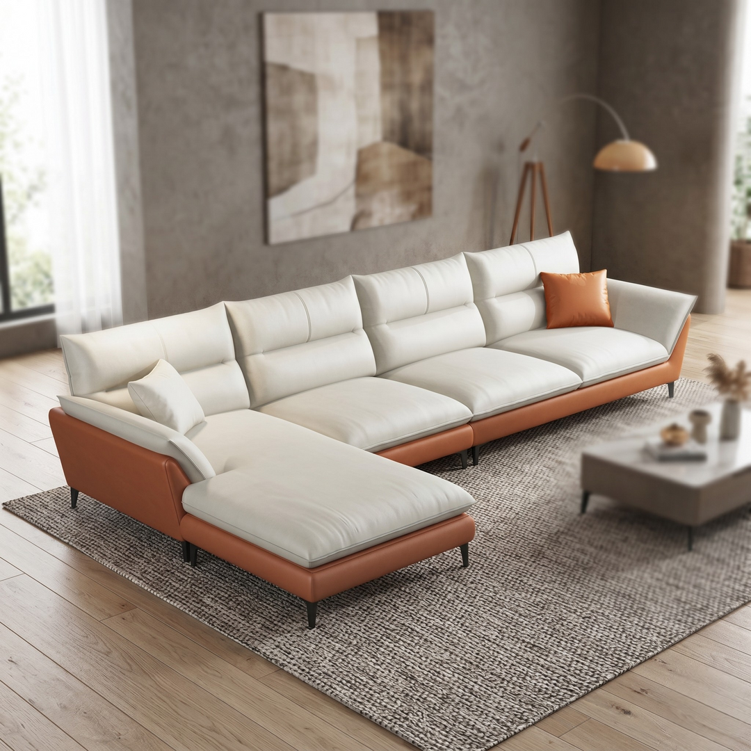 Modern sectional sofa with white cushions and brown leather accents in a living room setting.