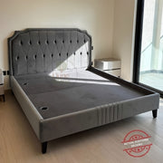 Upholstered bed kept in a bedroom without mattress