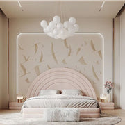 Modern bedroom with a pink curved headboard and decorative wall art.