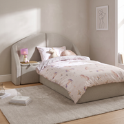 Boden Upholstered Bed with Side Table Storage shown in greige fabric in a bright bedroom – illustrative image – Dune & Pine