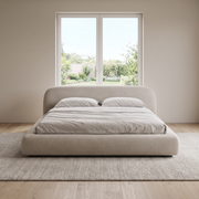 Luma Curve upholstered bed with hydraulic storage in light beige fabric in a bright bedroom