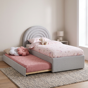 Farris Upholstered Trundle Bed shown in light grey fabric in a bright bedroom – illustrative image – Dune & Pine