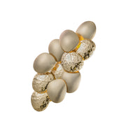 Decorative wall light fixture with beige and gold spherical elements on a white background