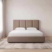 Nordique Panel Hydraulic Bed with Storage shown in mocha fabric in a bright bedroom – illustrative image – Dune & Pine