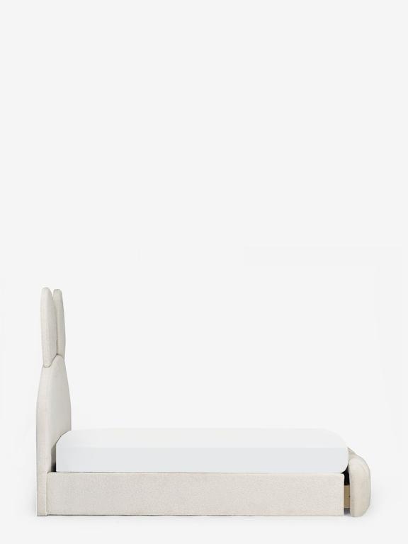 White bed with a white mattress on a white background