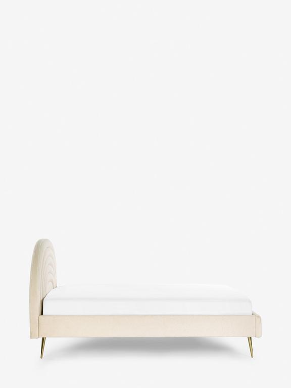Beige bed with a tufted headboard on a white background