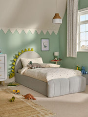 Children's bedroom with a gray bed, toys, and a green wall.