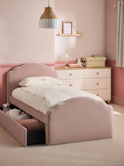 Children's bedroom with a pink bed and dresser.