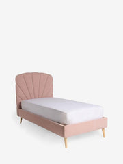 Pink bed with white mattress on a light gray background