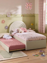 Children's bedroom with a bed, pink blanket, and toys.