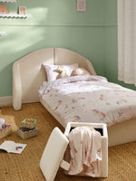Load image into Gallery viewer, Children's bedroom with a bed and storage ottoman against a green wall.